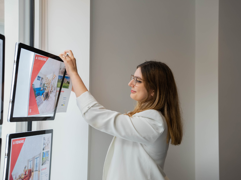 Agent immobilier dans l'étalage de l'agence.